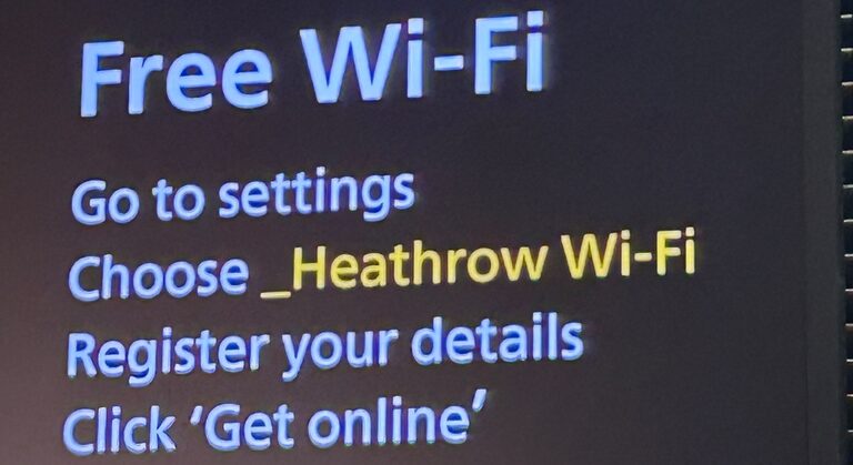 A screen in a Heathrow terminal headed "Free Wi-Fi", with the steps: go to settings, choose _Heathrow Wi-Fi, register your details, click 'Get online'