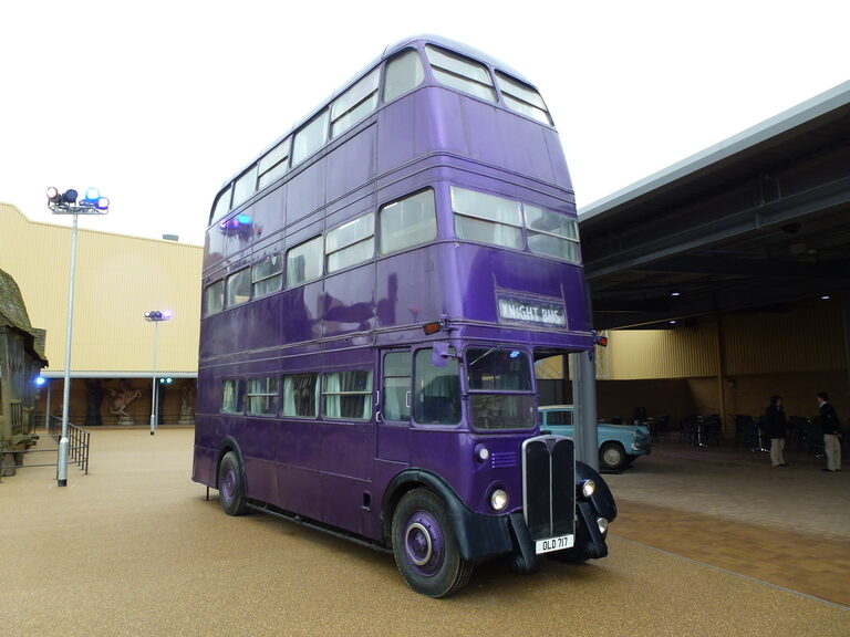 The purple triple-decker Knight Bus parked outside the studio buildings