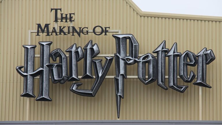 The silver "The Making of Harry Potter" sign, with a lightning-bolt P, on the studio's ribbed beige wall