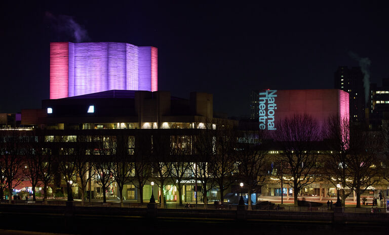 The National Theatre lit up at night, seen from Waterloo Bridge