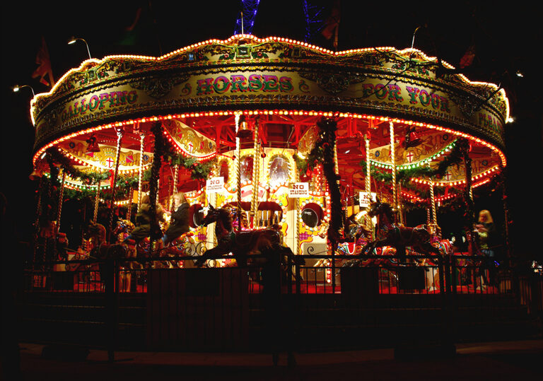 The Golden Carousel on the Queen's Walk, lit up at night