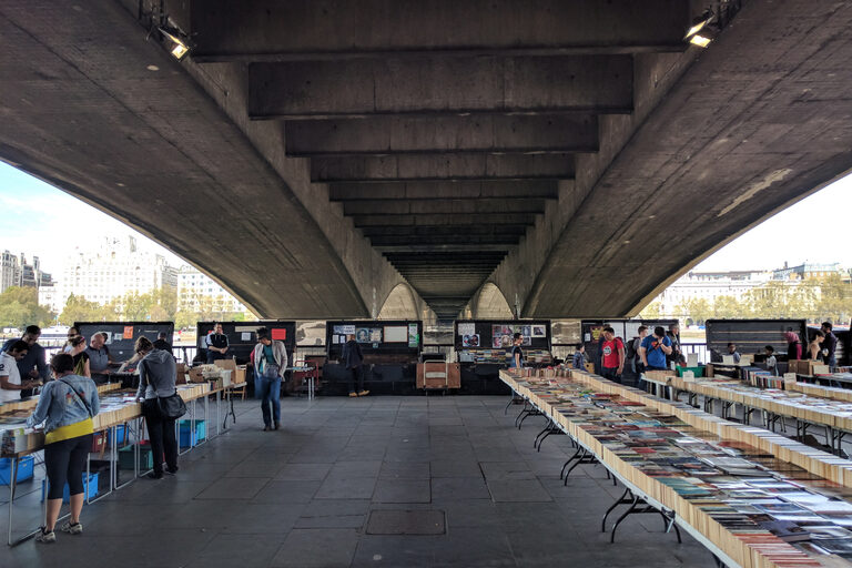 Second-hand book tables under Waterloo Bridge at the South Bank Book Market